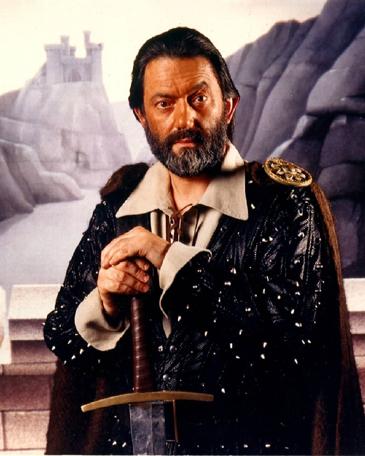 Full promotional shot of Treguard (Hugo Myatt), set against castle background.